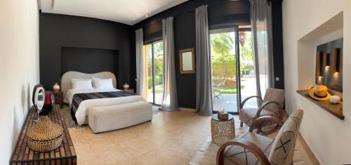 a bedroom with a bed and a living room at villa Bidouane in Marrakesh