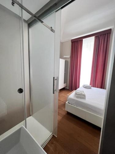 a bathroom with a shower and a bed and a tub at B&B TIVÌTTI in Palermo
