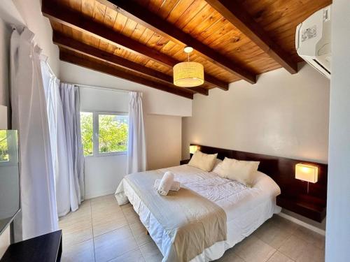 a bedroom with a bed and a window at Sea Point By D&G in Carilo