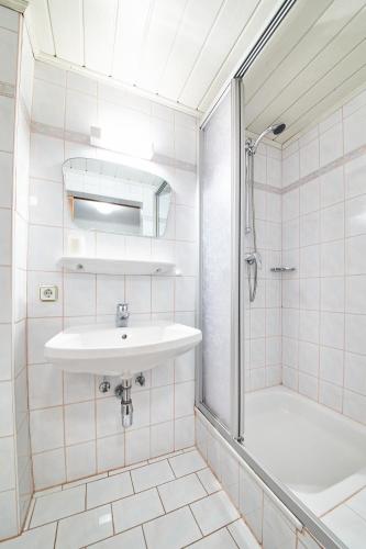 a white bathroom with a sink and a shower at Holiday Home Viehhofen in Viehhofen