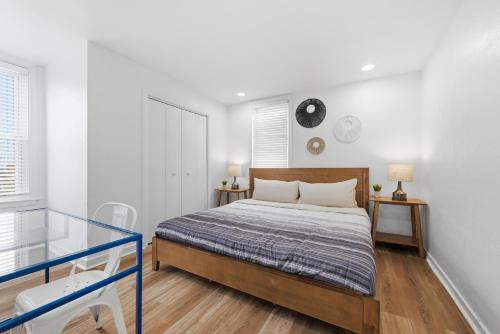 a white bedroom with a bed and two tables at Dormont, Pittsburgh !A Spacious and Modern Private Bedroom with Shared Bathroom in Pittsburgh