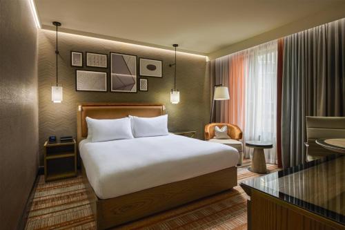 a hotel room with a bed and a desk at Hilton London Tower Bridge in London