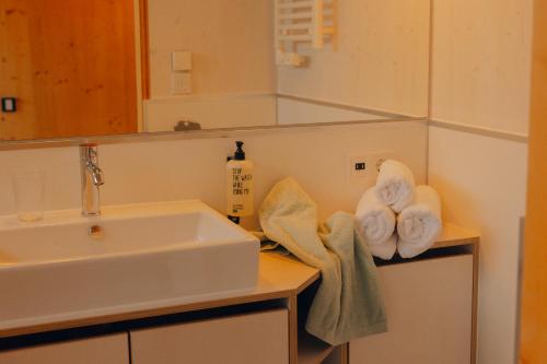 a bathroom with a sink and towels on a counter at cabinski Montafon in Sankt Gallenkirch