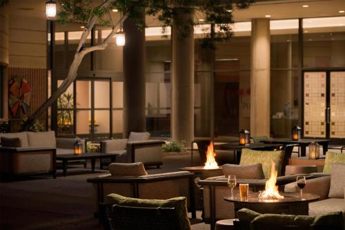 a lobby with tables and chairs with fires in them at DoubleTree Suites by Hilton Phoenix in Phoenix