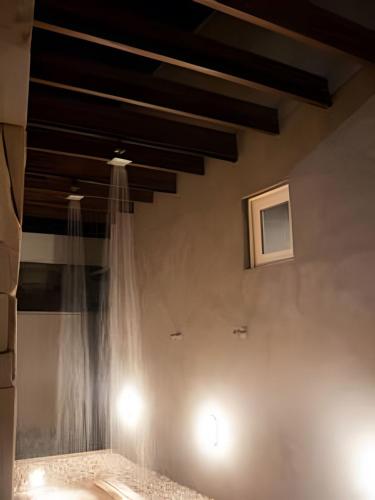 a room with a curtain on a wall with lights at Condominio Uhane Luxury Villas in São Miguel do Gostoso