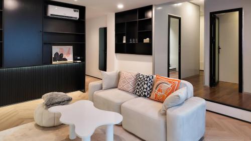 a living room with a couch and a table at Metrolux By ZG in Ho Chi Minh City