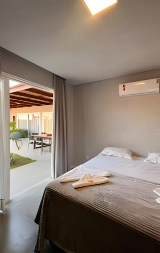 a bedroom with a bed with two towels on it at Condominio Uhane Luxury Villas in São Miguel do Gostoso
