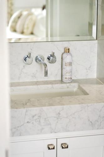 a bathroom sink with a soap bottle on it at Landguard - Yarmouth in Yarmouth