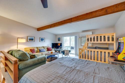 a living room with a couch and a crib at Spacious Bartlett Condo w/ Balconies & Pool! in Bartlett