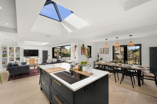 a kitchen and living room with a dining room and a table at Gilmore House - 5 Bedroom Victorian Home with Hot Tub in Blairgowrie