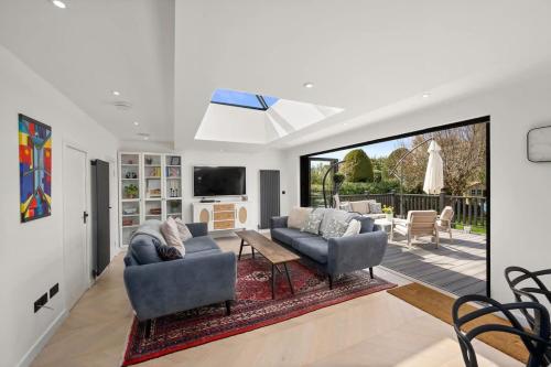 a living room with two couches and a tv at Gilmore House - 5 Bedroom Victorian Home with Hot Tub in Blairgowrie