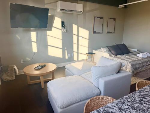 a living room with a couch and a table at Studio Apt King Bed Full Kitchen By KeenStays in Cape Girardeau
