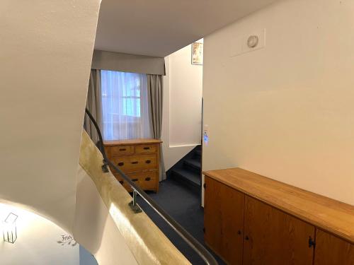 a hallway with a stairway leading to a room at Gasthof Rössle in Sulzberg