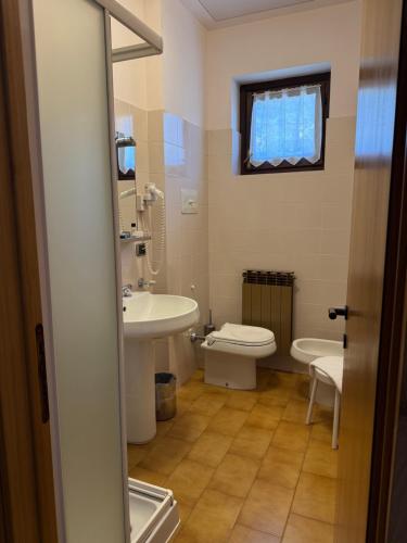 a bathroom with a toilet and a sink at Euro Hotel in Edolo