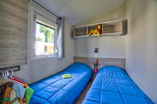 Postel nebo postele na pokoji v ubytování Camping APV Moncalm