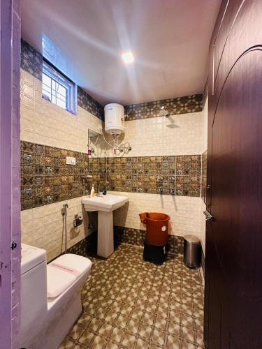 a bathroom with a sink and a toilet and a tub at Shail Shikhar Heritage Inn in Joshīmath