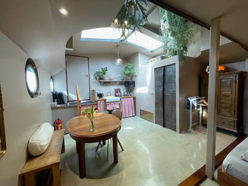 a kitchen and dining room with a wooden table at Houseboat Tante Piet in Amsterdam