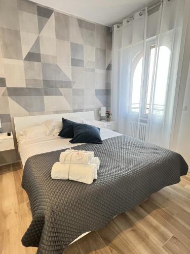 a bedroom with a bed with towels on it at Sottovento Beths House in Brenzone sul Garda
