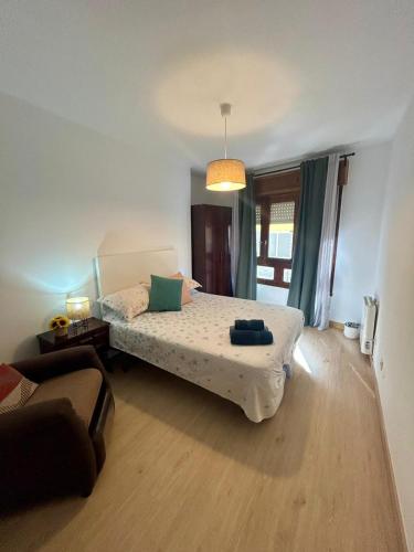a bedroom with a bed and a couch at Del Valle 1 in Cudillero