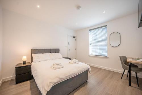 a bedroom with a bed and a desk and a mirror at 38 Prospect Place, Leiston in Leiston