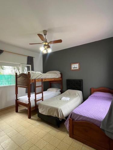 a bedroom with two bunk beds and a ceiling fan at Casa Kempes in Córdoba