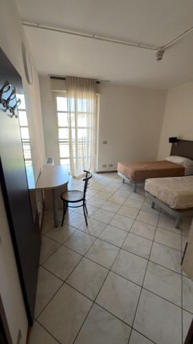a room with a room with a bed and a table at Savi Residence in Savigliano