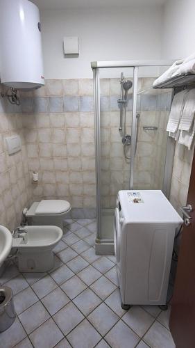 a bathroom with a shower and a toilet and a sink at Savi Residence in Savigliano