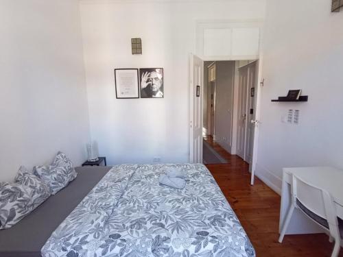 a white room with a bed and a table at Embassy Arriaga Private Elegance Rooms in Stylish Shared Apartment in Lisbon