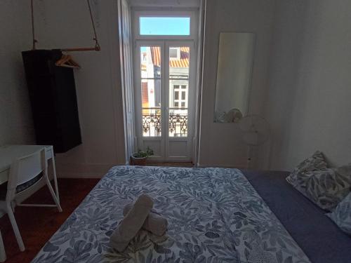 a bedroom with a bed with two teddy bears on it at Embassy Arriaga Private Elegance Rooms in Stylish Shared Apartment in Lisbon