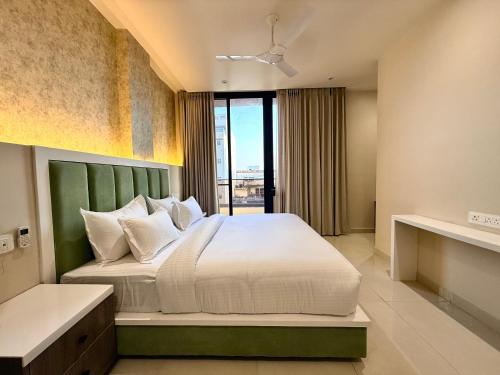 a bedroom with a large bed and a window at Novosol Lux- A Premium Hotel Near Airport in Jaipur