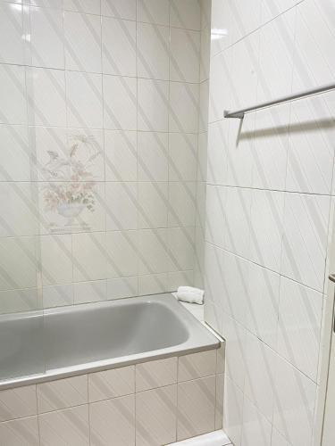a white bathroom with a tub and a sink at Vila Hotel By VimaHotels in Guimarães