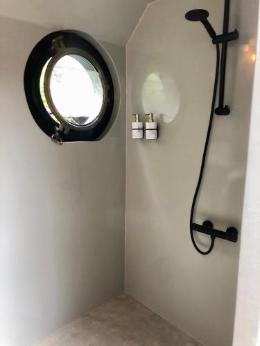 a bathroom with a window and a shower at Houseboat Tante Piet in Amsterdam