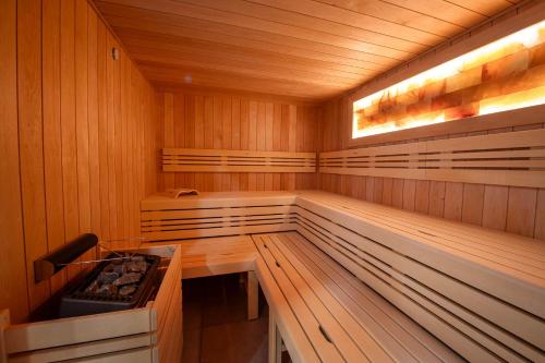 a sauna with wooden paneling and a bench in it at Hotel Villa in Prague