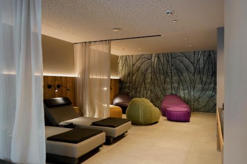a living room with a couch and two chairs at Aparthotel Chalina by Peak Stay in Leutasch