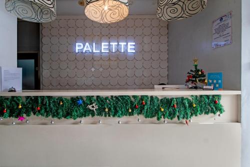 a row of christmas trees on a shelf in an office at Palette Legian Beach in Legian