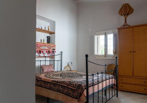 a bedroom with a bed and a dresser at Finca Antas Villa in Antas