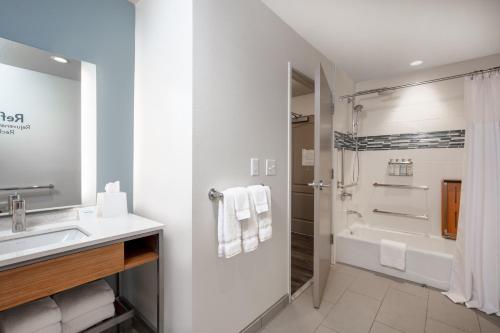 a white bathroom with a sink and a shower at EVEN Hotels Denver Tech Center-Englewood by IHG in Centennial