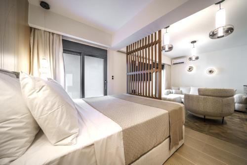 a hotel room with a bed and a chair at Allegro Suites in Rethymno