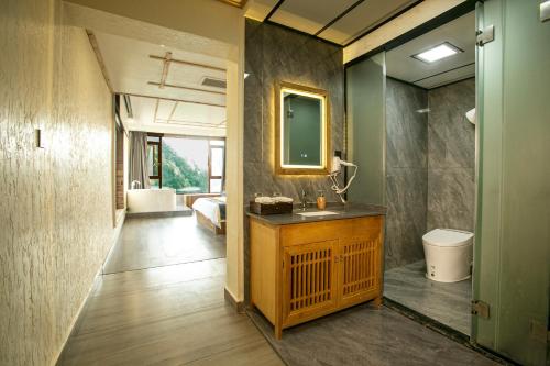 a bathroom with a sink and a mirror at Mountain-scenery inn in Zhangjiajie