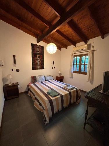 a bedroom with a large bed in a room at Cabañas Kidamalau in Merlo