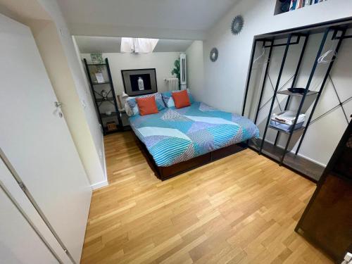 a bedroom with a bed and a wooden floor at Appartamento - Mini Suite in Brescia
