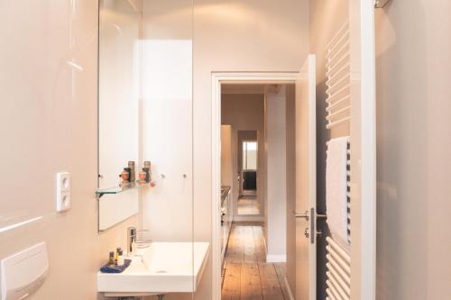 a bathroom with a sink and a mirror at OSTKÜSTE - Villa Albatros Design Apartments in Ahlbeck