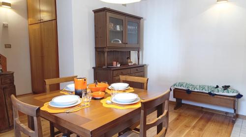 a dining room with a wooden table and chairs at Casa Savilla by Ca-Sa Check in Pieve di Cadore