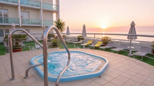 a hot tub on the balcony of a hotel at Igea Spiaggia Home Holiday in Bellaria-Igea Marina