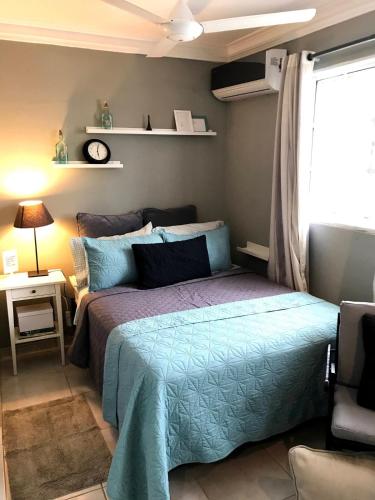 a bedroom with a bed with a blue comforter at Independent, central studio Apt3-A in El Seis