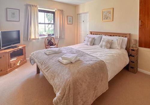 a bedroom with a large bed and a television at Rubbing House in Marske
