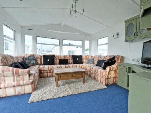 a living room with a couch and a coffee table at Minster - Uk51005 in Eastchurch