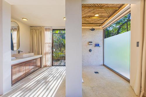 a bathroom with a shower and a sink at Tiki Villas Rainforest Lodge - Adults Only in Uvita
