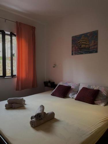 a bedroom with a large bed with towels on it at Apartment Mladinić in Okrug Donji