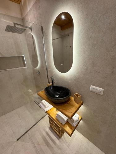 a bathroom with a black sink and a mirror at L'Atrio Suite in Torre del Greco